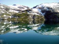 Snow Covered Mountains Meet the Sea in Greenland